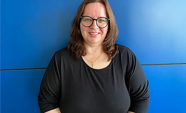 Miriam Petersen, Assistenz Luftfracht Freiburg, steht vor einer blauen Wand